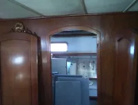 VIP aft stateroom with built in queen bed looking to Port side en suite head/shower and tub with sink and vacu-flush head