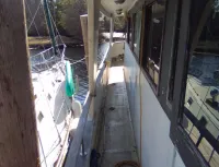 Starboard side glass deck with covered walkways, boarding station, very tall side railings all around for safety